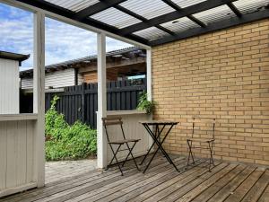a patio with two chairs and a table on a deck at Spacious Apartment for 5 in Odense