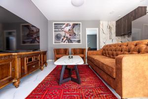 a living room with a couch and a table at Elijos Kopa in Šventoji