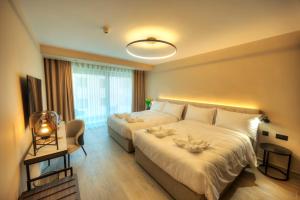 Postel nebo postele na pokoji v ubytování ASTE hotel
