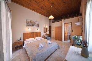 a bedroom with a bed with two pillows on it at Naftilos Guest House in Kala Nera