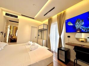 a bedroom with a large bed and a fish tank on the wall at Empire of Martin in Gjirokastër +44 photos