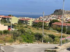 a view of a city with houses and the ocean at Castle View - Vista Castello in Castelsardo