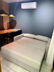 a room with a bed and a dining room with a table at Canto da Jandaia Imbassaí in Imbassai +13 photos