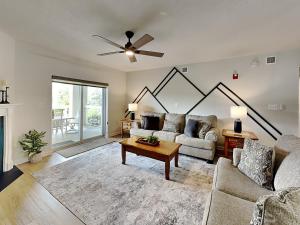 a living room with a couch and a table at Mountain Breeze Retreat at Whispering Pines 512 in Pigeon Forge
