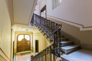 a staircase in a house with a wrought iron railing at Matera In Vacanza in Matera