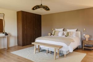 a bedroom with two beds and a wooden cabinet at Mas de l'Etoile in Aureille +31 photos