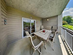 a patio with a table and chairs on a balcony at Mountain Breeze Retreat at Whispering Pines 512 in Pigeon Forge +27 photos