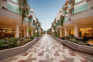 an empty hallway of a building with palm trees at Liberty Signa in Fethiye