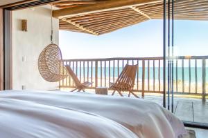 a bedroom with a bed and a view of the ocean at Villa Mandi in Jericoacoara