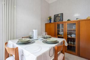 a dining room with a table with a white table cloth at Dimora Waterfront in Bari