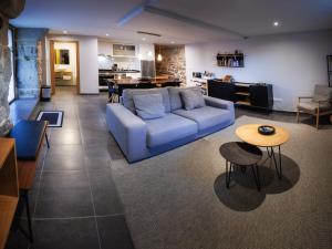a living room with a blue couch and a table at Casa Yañez • XuresVillas in Bubaces