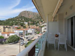 a balcony with chairs and a view of a city at Apartamentos Las Brisas 3-2 in Torroella de Montgrí