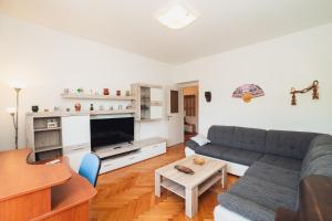 a living room with a couch and a table at Spinut Urban Retreat in Split