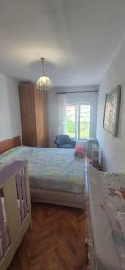 a bedroom with a large bed and a window at Herceg Novi, Topla, 10 min from the sea in Španjola