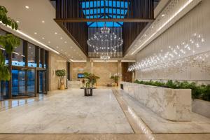 a lobby with a chandelier in a building at Liberty Signa in Fethiye