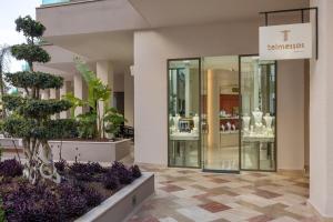 a store with glass doors and plants in a mall at Liberty Signa in Fethiye