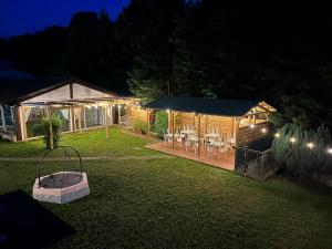 a backyard at night with a pavilion with a table and chairs at B&B Villa degli Aceri in Carcare
