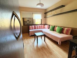 a living room with a couch and a table at Apartamento La Marquesa Beach in Puertito de Güímar