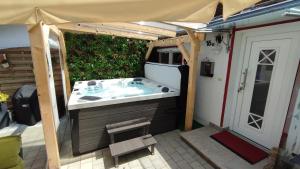 a hot tub under a tent in a backyard at Ferienhaus Gabriela Allgäu in Immenstadt im Allgäu