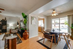 a living room with a table and a couch at Walk to Golf Club Sun City Home with Private Pool! in Sun City