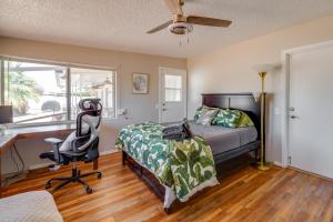 a bedroom with a bed and a desk and a chair at Walk to Golf Club Sun City Home with Private Pool! in Sun City +23 photos