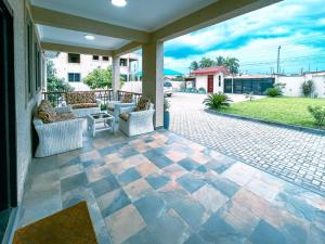 une terrasse avec des canapés et une table dans l'établissement Maryland House in Com 20 Tema Greater Accra Ghana, à Kwedonu