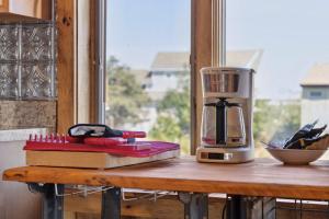 a coffee maker sitting on a table next to a window at Basin Perch Basin Views Sunsets AC Deck in Plum Island