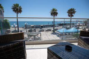 a balcony with a view of a parking lot and the ocean at Nery Home Luxury Sea View Giardini Naxos in Giardini Naxos