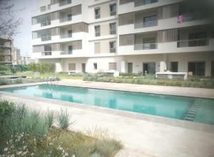a swimming pool in front of a building at Zenitude in Casablanca