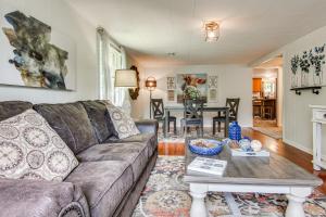 a living room with a couch and a table at Private Hot Tub Cottage Near Hikes and Pigeon River in Canton