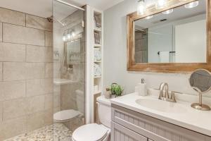 a bathroom with a sink and a toilet and a mirror at Private Hot Tub Cottage Near Hikes and Pigeon River in Canton +18 photos