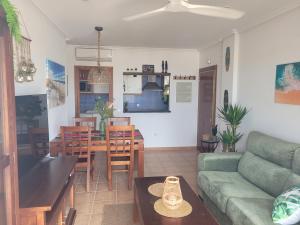 a living room with a couch and a table at Ático El Mirador in Vera