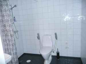 a white bathroom with a toilet and a shower at Kullens Bed and Breakfast in Mellby