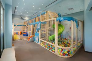 a childrens play room with a large cage filled with toys at Liberty Signa in Fethiye