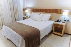 Rúm í herbergi á Bella Vista Hotel - Encarnación
