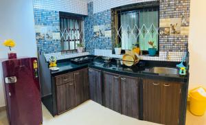 a kitchen with a refrigerator and a sink at Hidden Gem agonda in Agonda