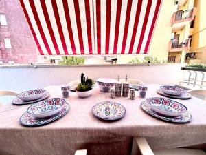 a table with blue and white plates on it at Quadrilocale vista mare completamente climatizzato in Gallipoli
