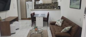 a living room with a couch and a table at Casa & Jardim Riviera in Riviera de São Lourenço
