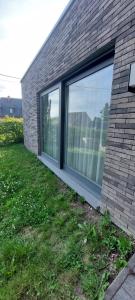 a brick building with large windows on the side of it at l'Annexe in Mellet +2 photos