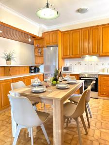 a kitchen with a wooden table and chairs at CityCenter Apartment in Argostoli