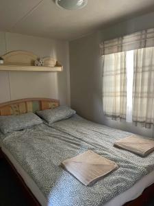 a bedroom with a bed with two pillows and a window at Riviera Zator in Zator