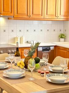 a table with glasses of wine and fruit on it at CityCenter Apartment in Argostoli