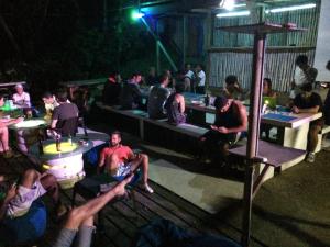 a group of people sitting at tables in a bar at Blue Dream Kite Boarding Resort Costa Rica in Puerto Soley