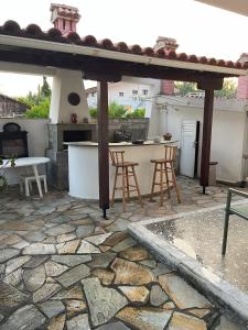 a patio with a table and chairs and a kitchen at Aelia Seaside Maisonette in Neoi Epivates