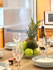 a table with wine glasses and a plate of fruit at CityCenter Apartment in Argostoli +18 photos