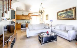 a living room with a couch and a table at Aelia Seaside Maisonette in Neoi Epivates
