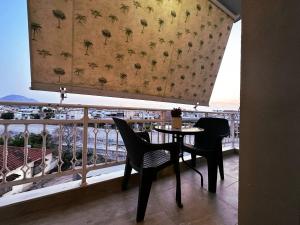 a table and chairs on a balcony with a view at D&S Coastal Stay in Korinthos in Korinthos