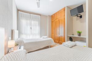 Postel nebo postele na pokoji v ubytování Hostal El Bugar