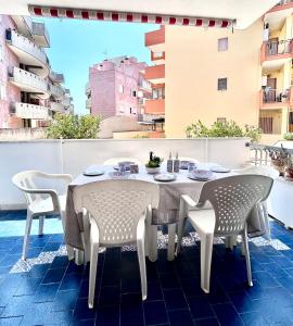 a white table and chairs on a balcony at Quadrilocale vista mare completamente climatizzato in Gallipoli