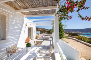 a porch with chairs and a view of the ocean at Silene Villas in Amoopi
